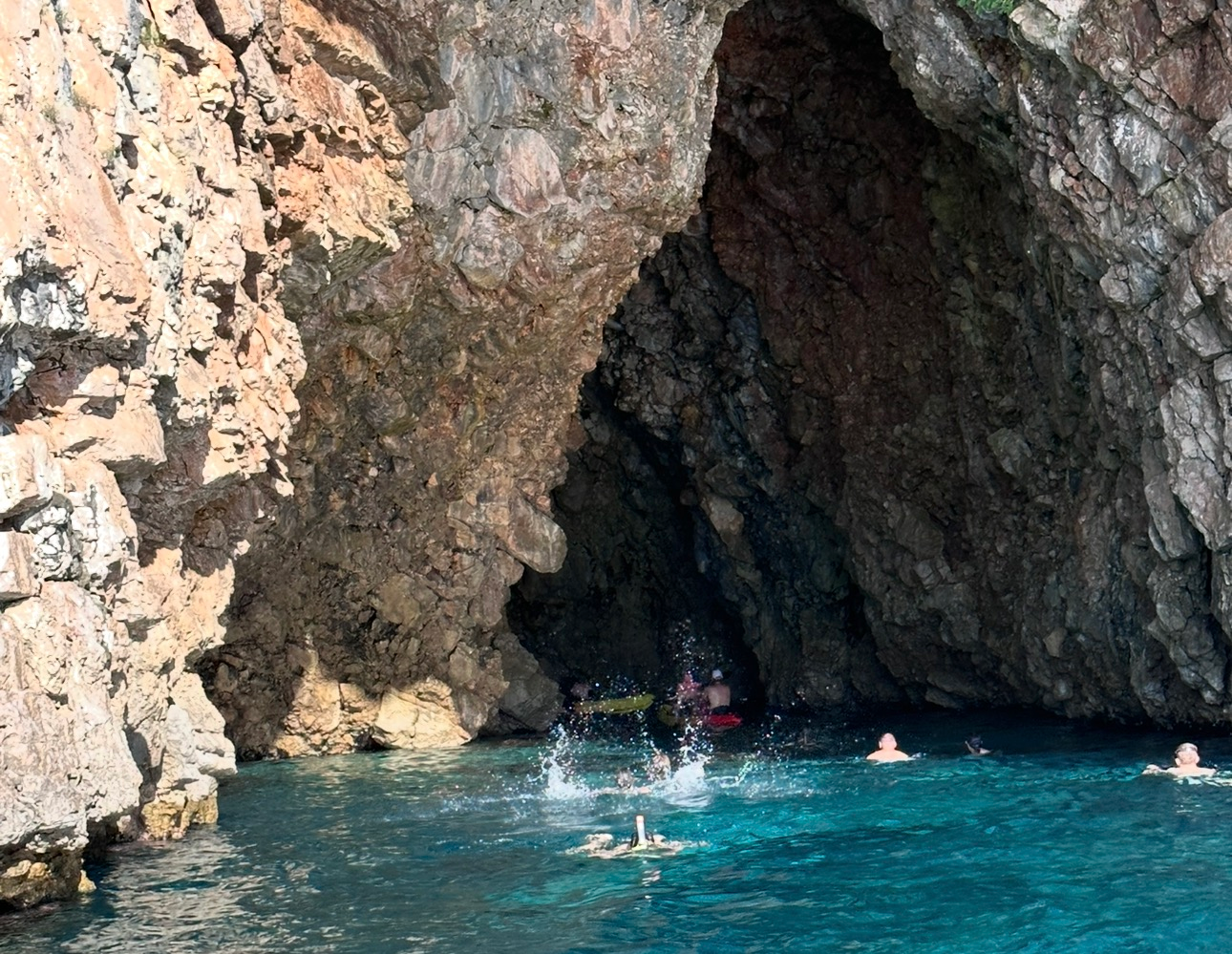 Blue Cave boat tour adventure with glowing blue water in Montenegro
